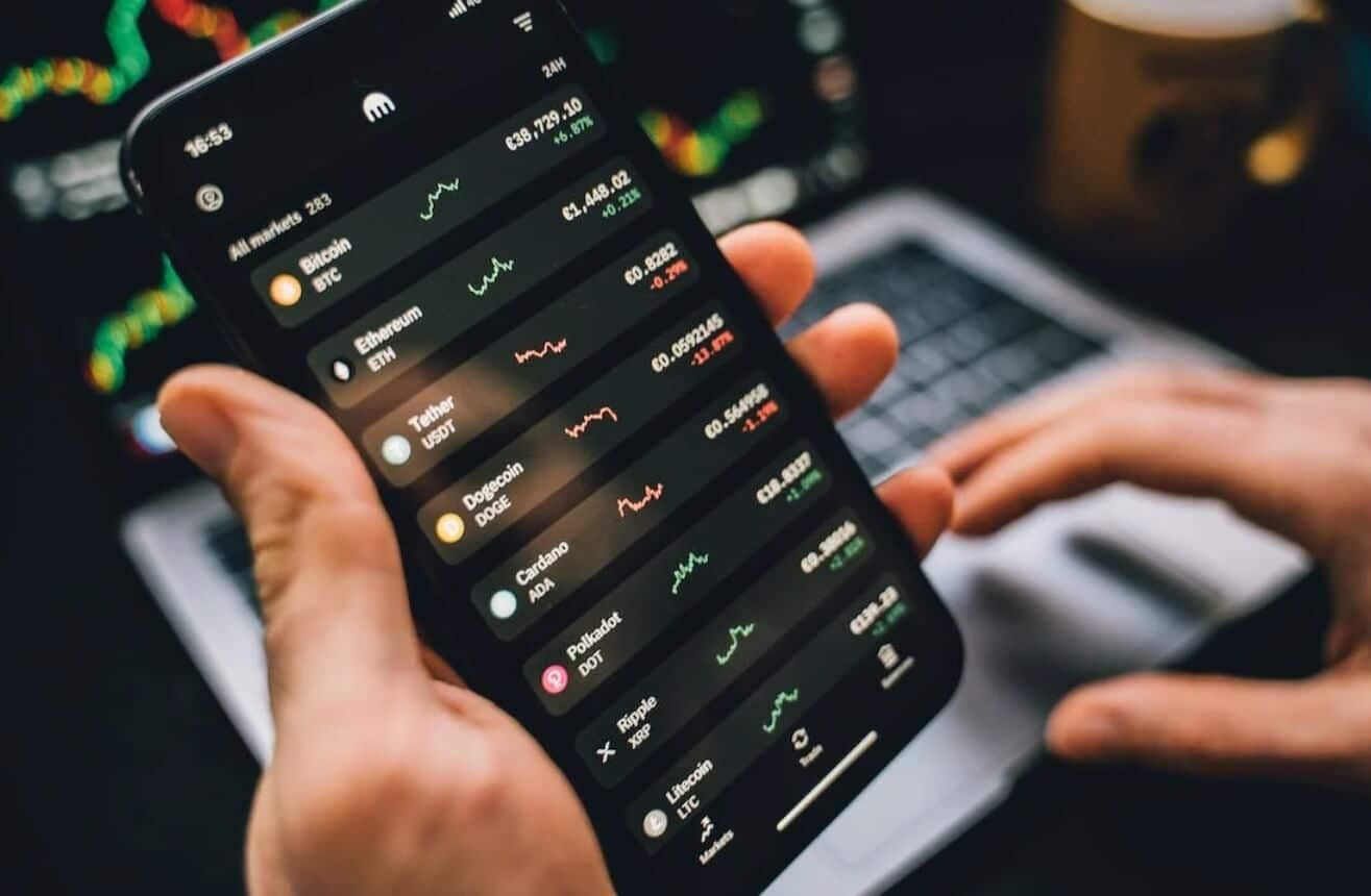 close up of phone showing open trading positions