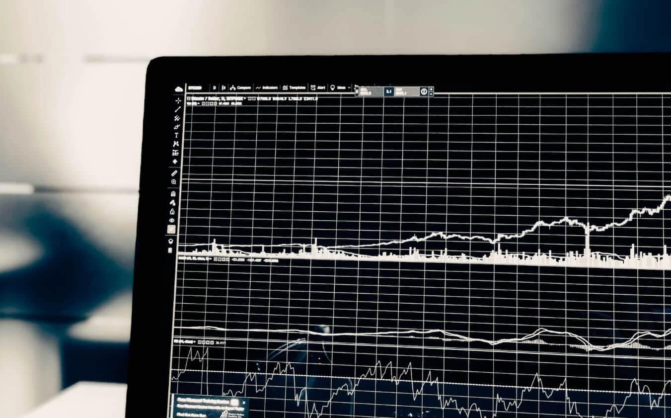 image of laptop with a black and white trading chart