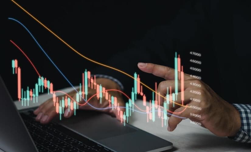 finger hovering over desk touching virtual trading chart