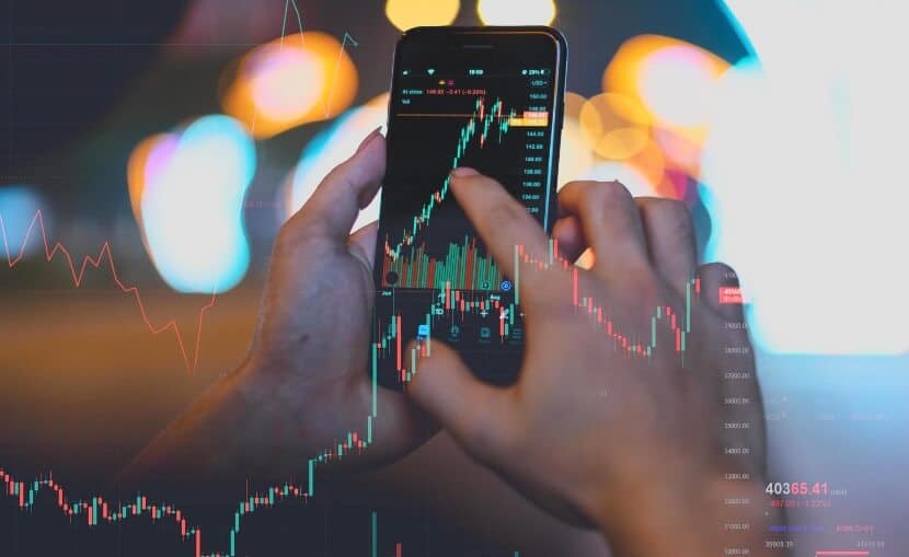 phone and hand with forex chart on phone