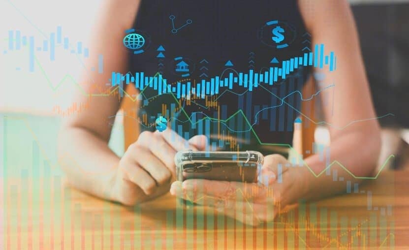 woman with phone showing virtual trading data blue