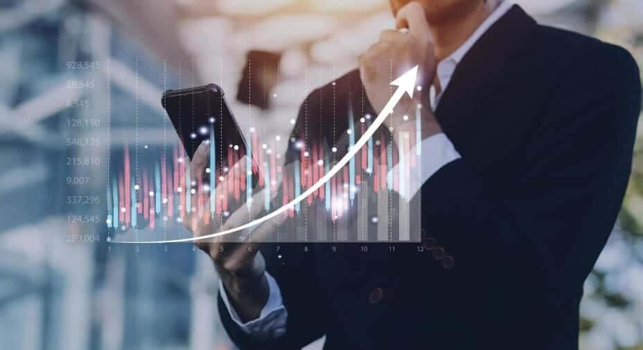 man looking at phone with forex chart overlay